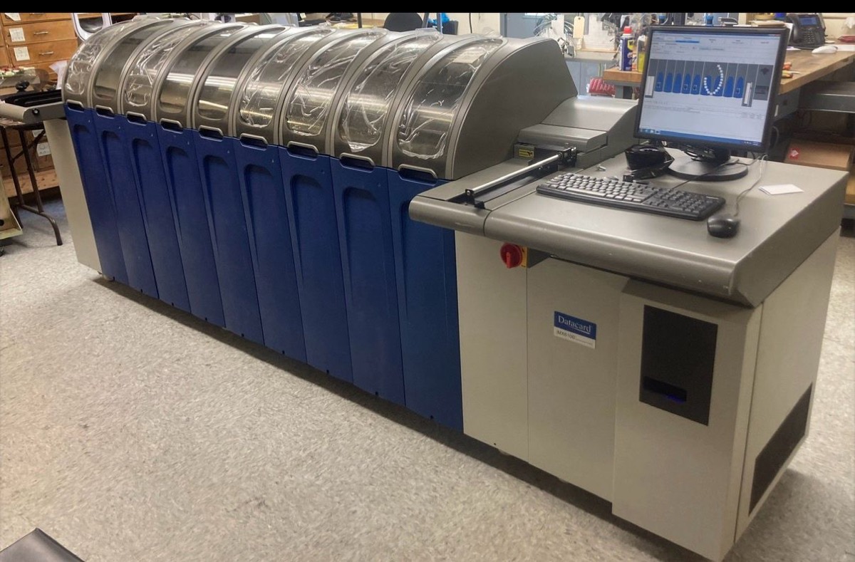 A Datacard MX6100 central issuance system on the workshop floor, with its card hoppers open and operator console alongside